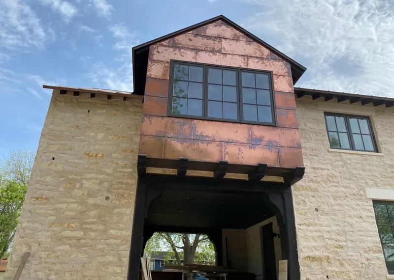Copper metal panel facade on a stone building for Roof Repair in Bel Air